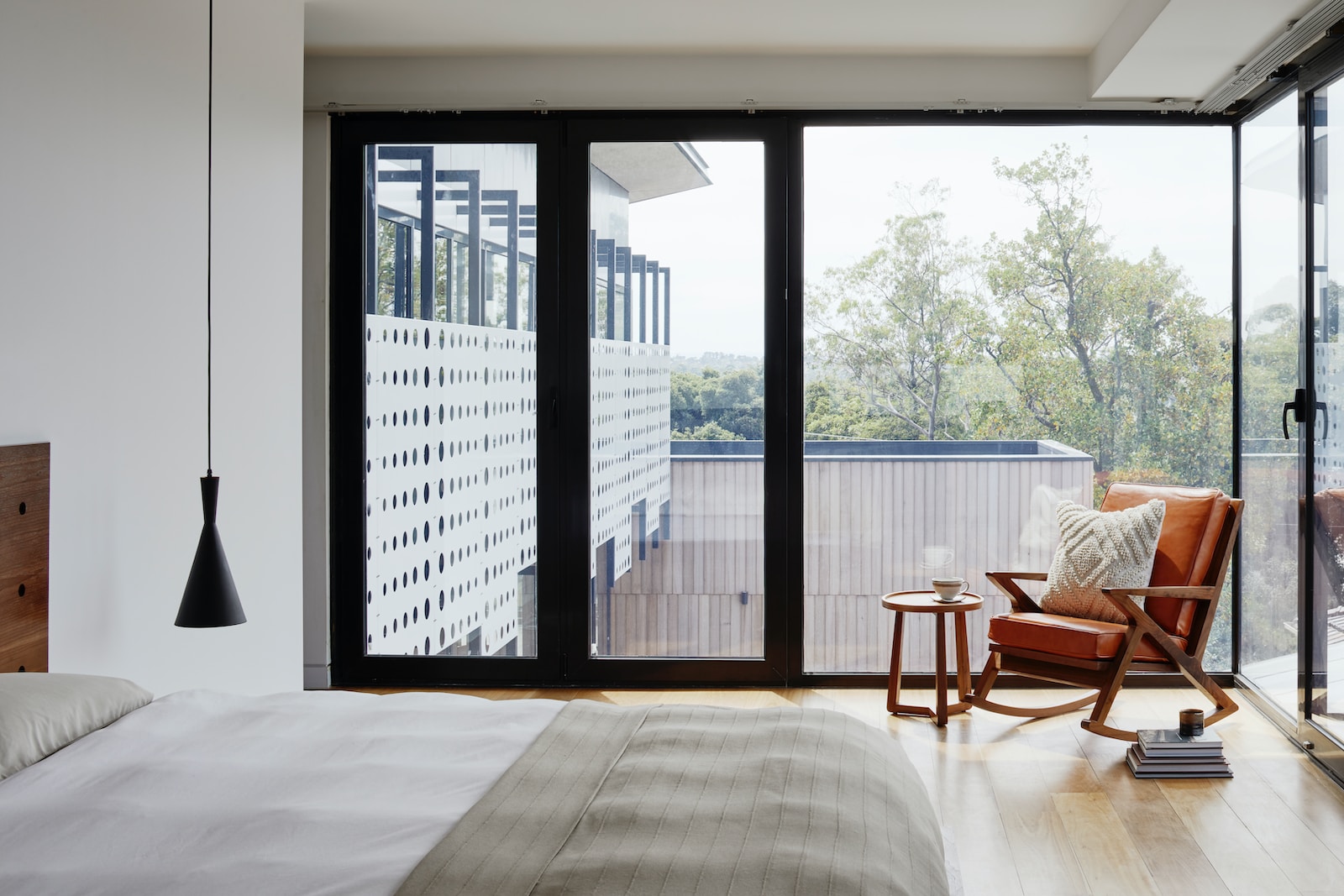 brown wooden armchair near glass window